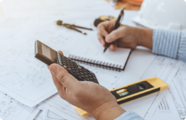 Image of person making notes and measuring.