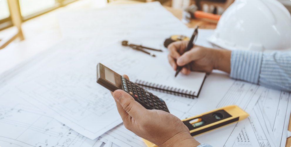 Image of person making notes and measuring.