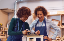 Two women building together.